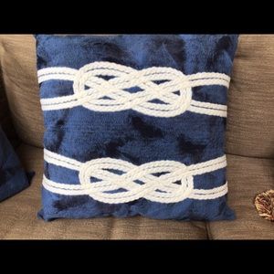 Nautical navy blue and white rope design pillow.